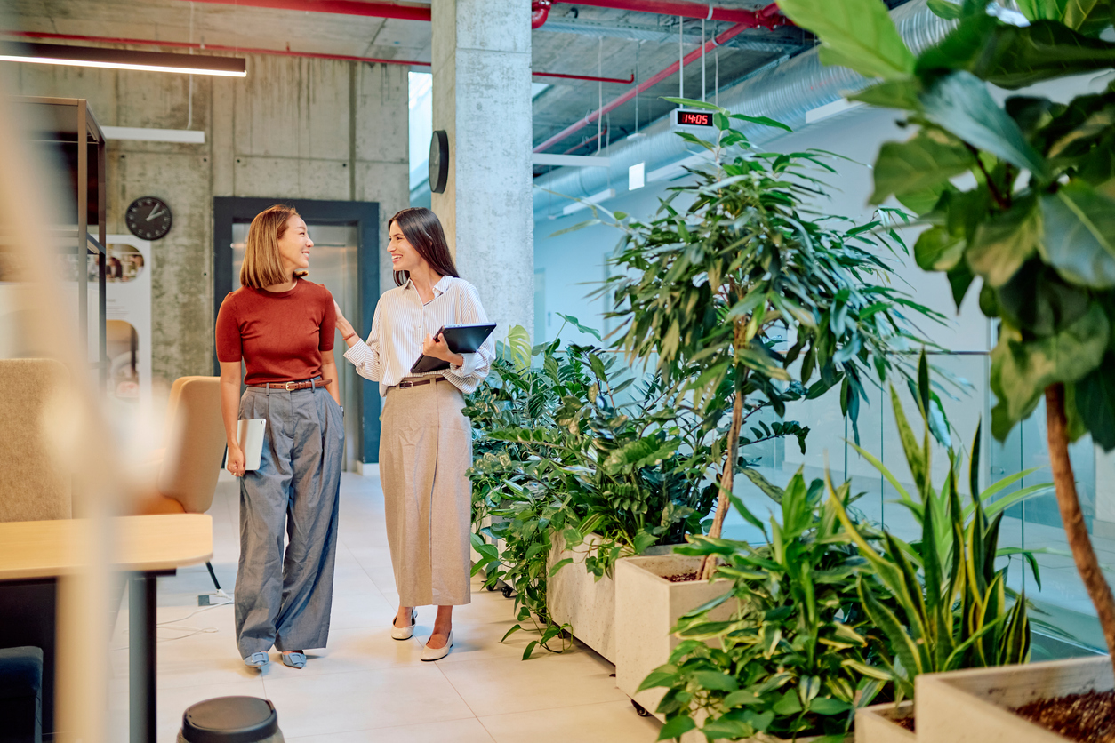 A manager and employee talking as they walk through the office